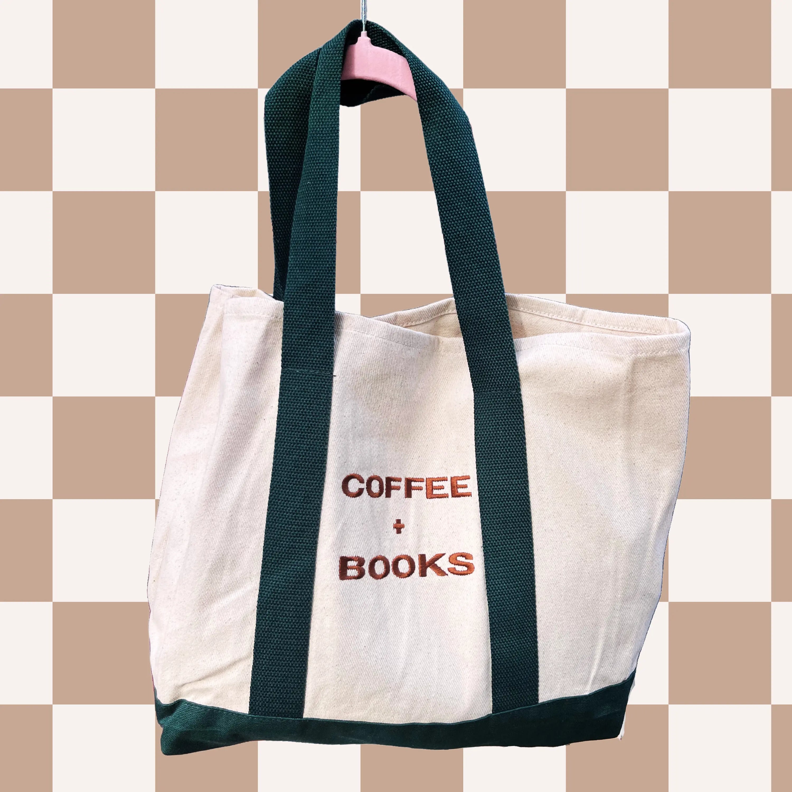 green and tan tote with the words coffee plus books embodied on it with brown lettering