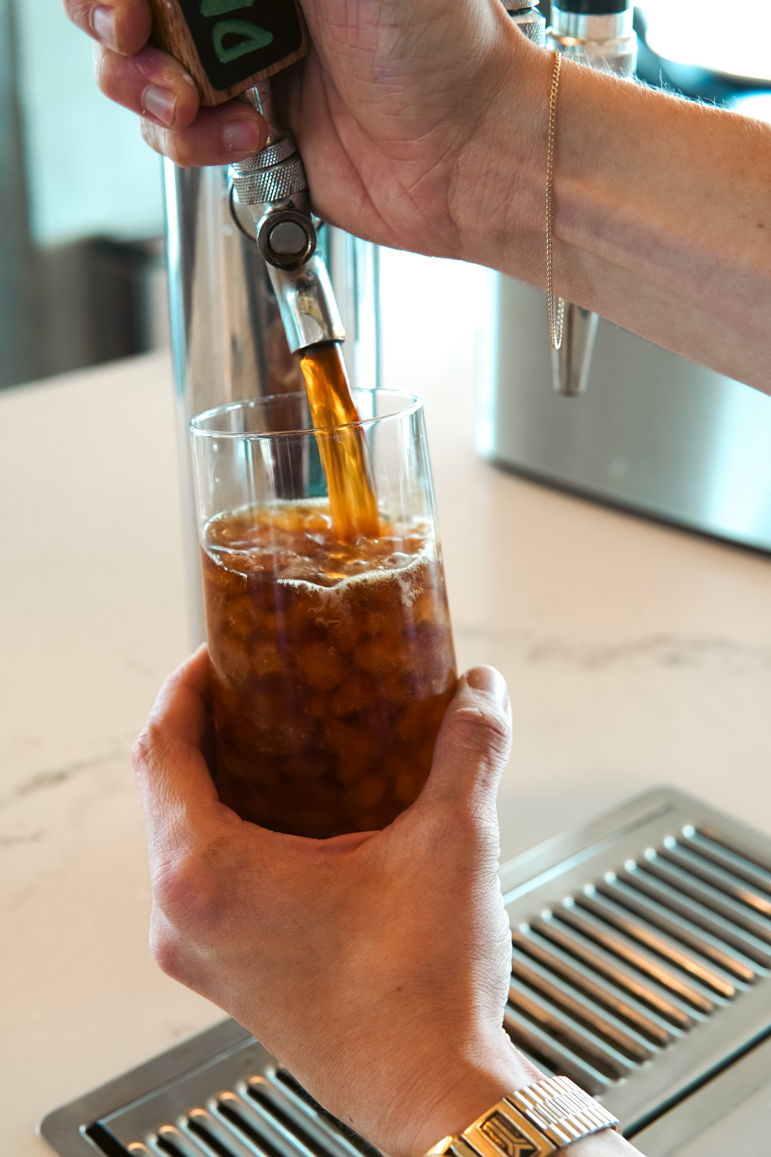 person pouring Coffee Man cold brew from a keg at an Atlanta Office 